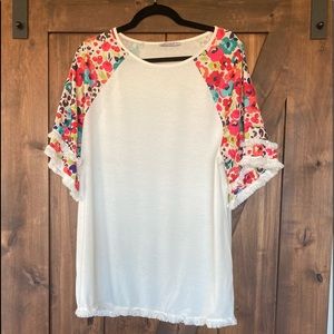 Fun, breezy, colorful shirt with fringy hems!